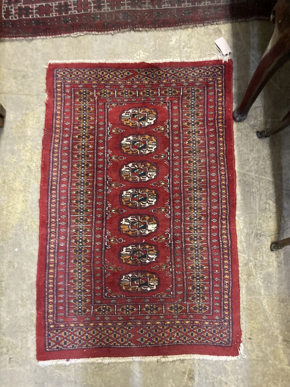 Two Afghan red ground rugs, largest 140 x 110cm